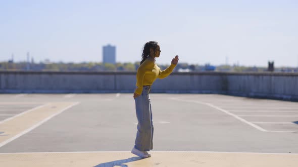 Happy black woman making a jump, slow motion side view