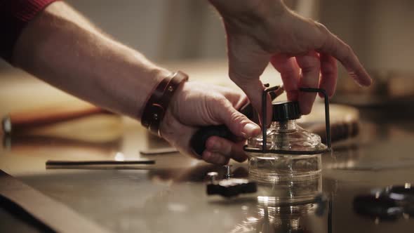 The Tailor Closes the Burner Using the Lid