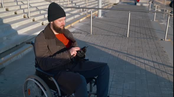 Disabled Man Texting on Mobile Being on City Stairway