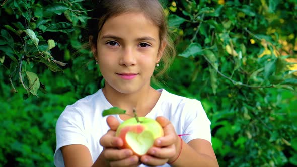 The Child Eats an Apple in the Garden