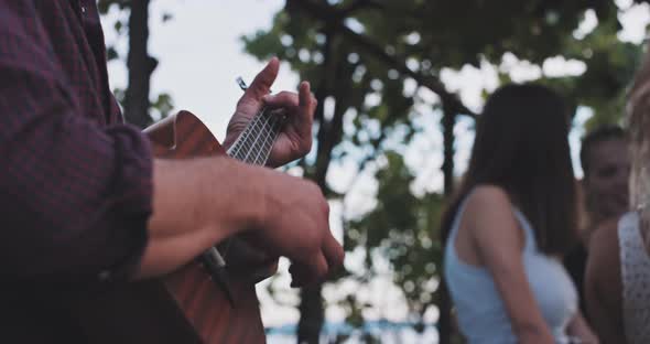 Handsome musician playing guitar and singing