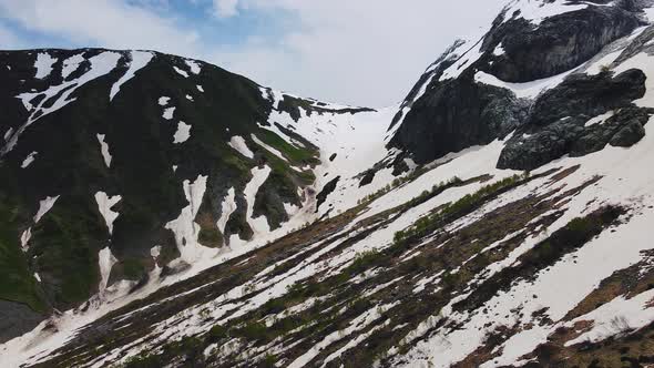 Mountain Ridge of Caucasian Range Partly Covered with Snow