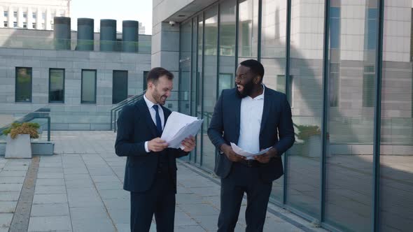 Two Amazed Diverse Businessmen Winner Celebrating Success Win Throw Up Business Papers Surprised to