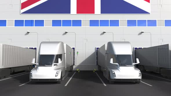 Trailer Trucks at Warehouse Loading Dock with Flag of the UK alt