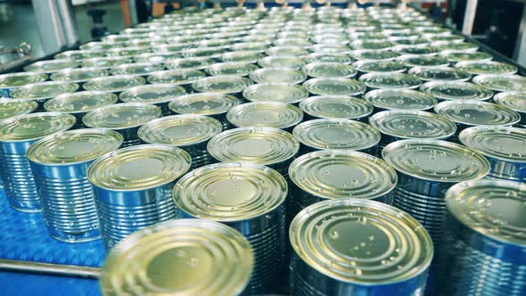 Conveyor with Tin Cans Getting Piled Up on It