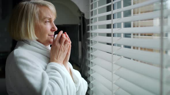 Video of sick senior woman looking out the window.  Shot with RED helium camera in 8K