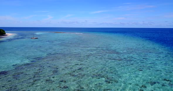 Wide angle above tourism shot of a white paradise beach and blue sea background in hi res 4K