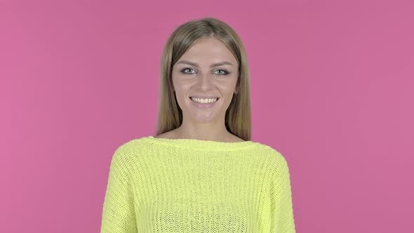 Happy Young Girl Smiling at Camera, Pink Background