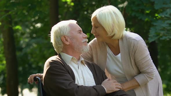 Old Handicapped Man Hugging and Kissing His Beautiful Wife, Pastime Together