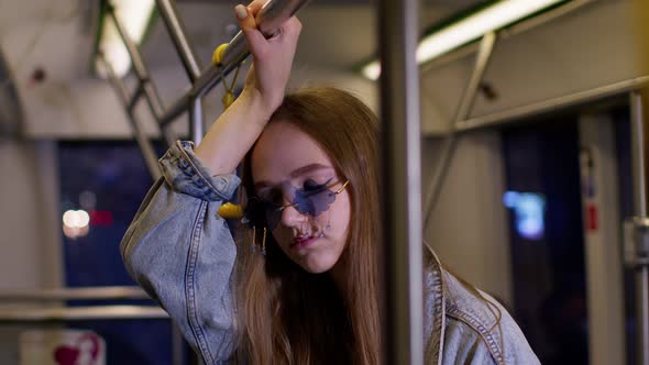 Tired Bored Young Woman Standing Alone in Bus Transport After Hard Work Day and Falling Asleep