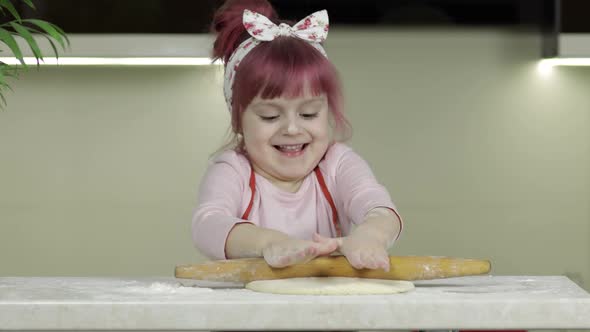 Cooking Pizza. Little Child in Apron Roll Dough with Rolling Pin at Home Kitchen