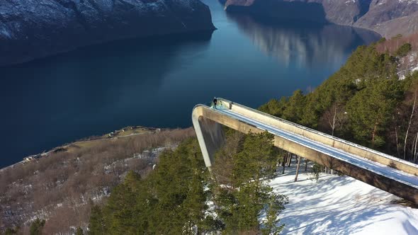 Breathtaking Segastein viewpoint high altitude aerial overview with person standing on edge - Rotati