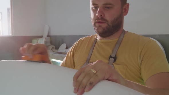 Male surfboard maker in his workshop