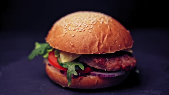 Great Burger with beef cutlet, tomatoes, mushrooms and cucumbers with melted cheese rotates