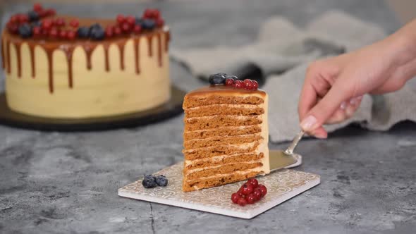 Piece of Layer Caramel Cake with Cream and Fresh Berries