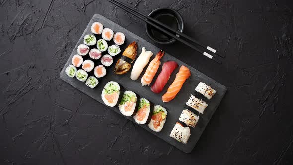Sushi Rolls Set with Salmon and Tuna Fish Served on Black Stone Board