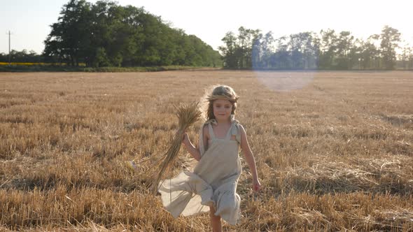 Girl Child in a Dress Runs Through a Mown