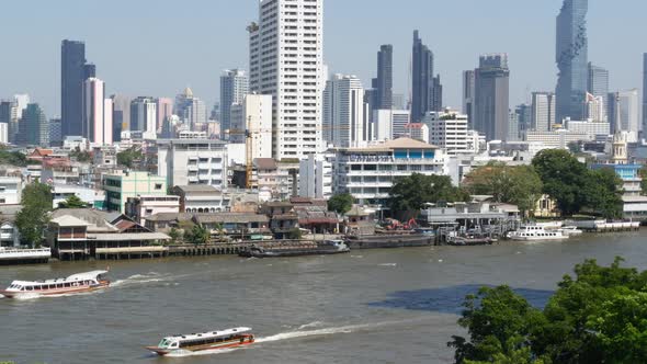 View of Skyscrapers Located on Shore of Tranquil Chao Praya