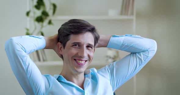 Close Up of Happy Caucasian Adult Man Wear Blue Shirt Relax Looking Away, Dreaming Resting, Sitting