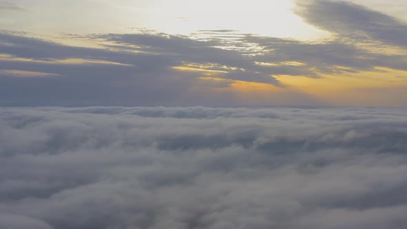 Aerial View Flying Through Cumulus Clouds at Sunset