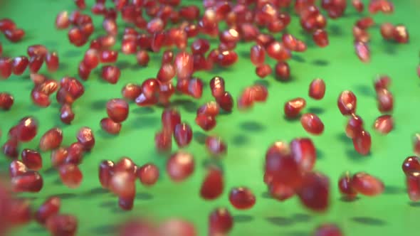 Pomegranate Grains on Green Background