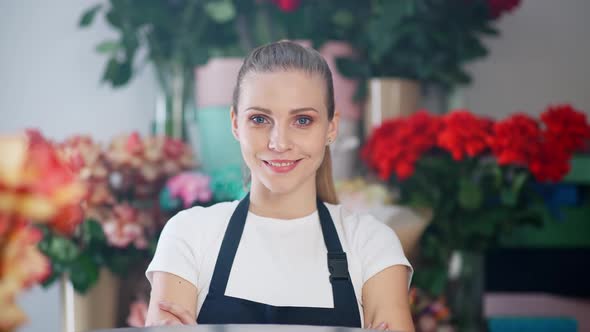 Portrait of Young Florist Female Beautiful Cheerful Woman Looks at the Camera and Smiles the
