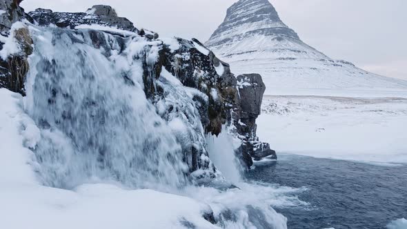 Drone Of Waterfalls And Frozen Landscape With Kirkjufell Mountain