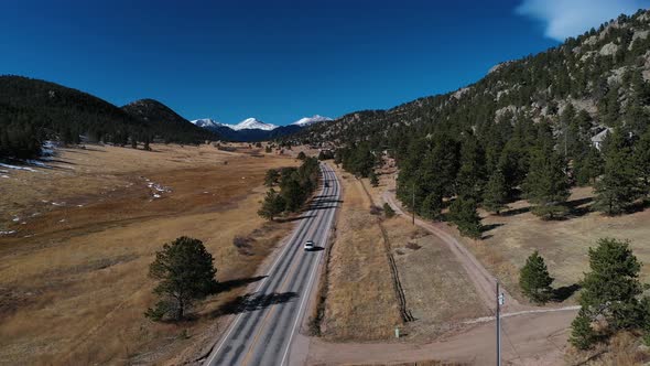 Cars on Snow Capped Mountain Highway Aerial Shot 4K