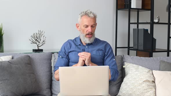 Modern Cheerful Senior Man Using Laptop for Video Connection