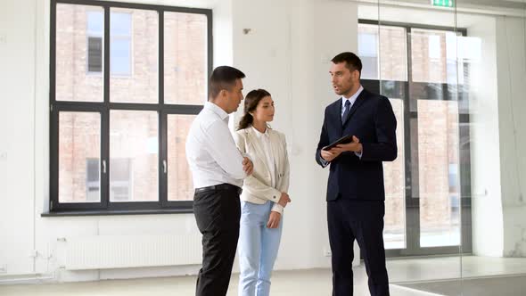 Realtor Showing Tablet Pc To Customers at Office 