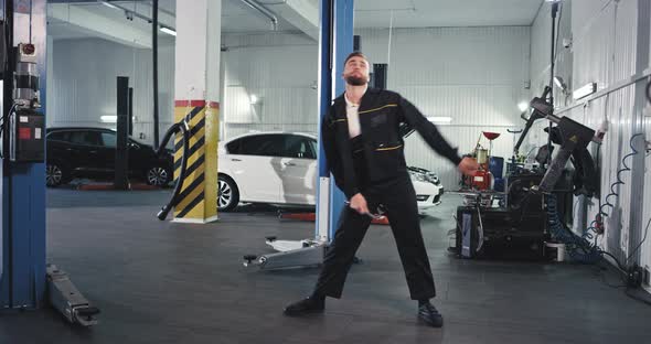 Good Looking Mechanic Man Dancing Excited in Front