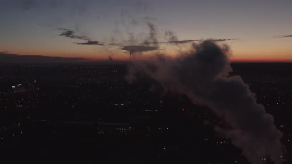 Top View of the Thick Smoke That Rises From the Chimneys Against the Sunset. The Main Boiler House