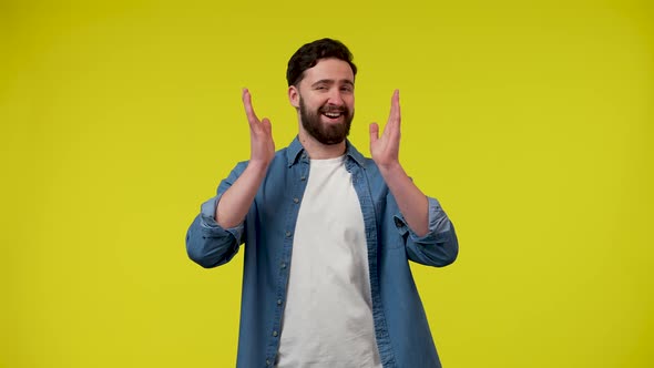 A Positive Bearded Man is Having Fun Dancing Moving Vigorously Pointing His Index Fingers Directly