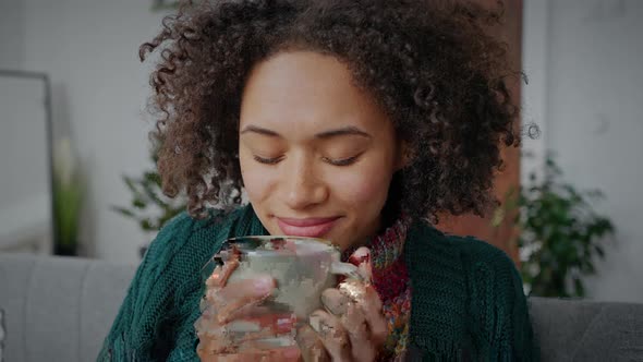 Close Up Portrait of Young African American Lady Drinking Hot Coffee Enjoying Cup of Her Favorite