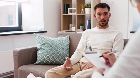 Senior Woman Psychologist and Sad Man Patient