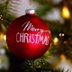 Merry Christmas.Red christmas ball close-up on christmas tree with shining garland - VideoHive Item for Sale