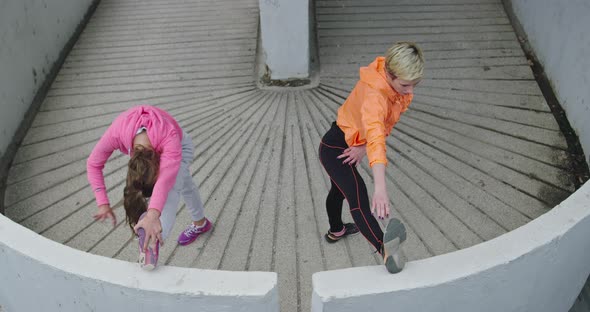Two Women Jogging and Stretchering in the City Sporty Lifestyle and Healthy Activity