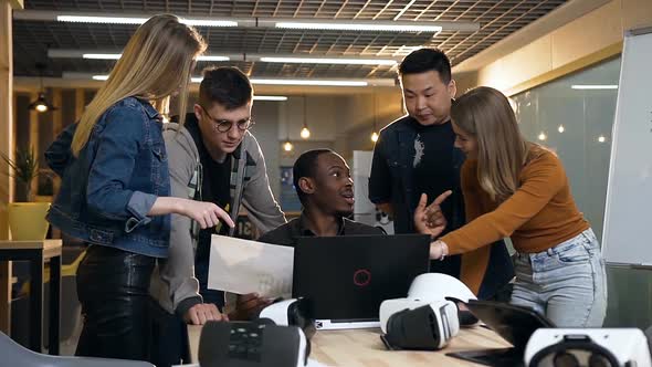 Group of Hipster People Working with Diagram Using Laptop