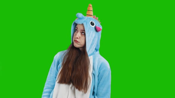 Portrait of a young brunette girl in unicorn costume