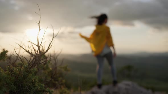 The Girl is Happy That She Conquered the Top of the Mountain