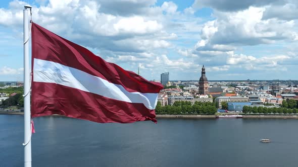 Latvian Flag with the Dome Cathedral and an Old Town in the Background in Riga Latvia