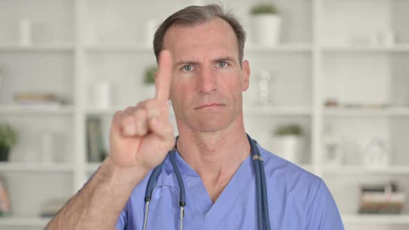 Portrait of Middle Aged Doctor Saying No with Finger Gesture 