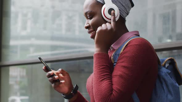 African american using her smartphone in street