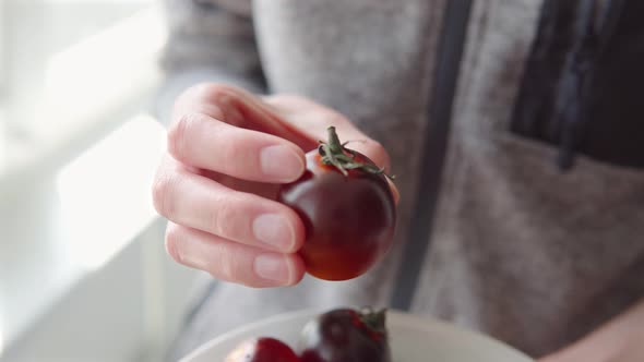 Closeup of a Ripe Black Tomatoes on a Plate