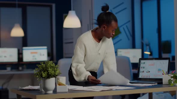 African Manager Woman Working with Financial Documents Standing at Desk