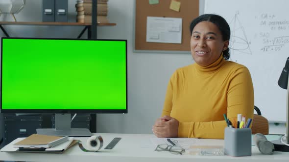 Online Courses Teacher Pointing at Computer with Chroma Key Green Screen Speaking During Distant alt