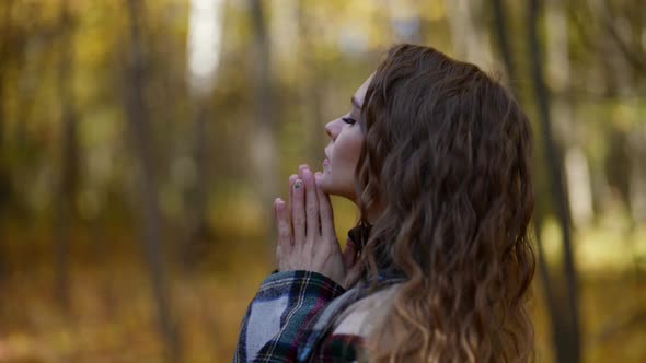 Portrait of a Blonde with Long Hair and a Plaid Coat in an Autumn Park