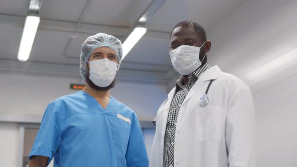 Portrait of Emergency Department Doctor and Nurse Wearing Safety Mask Looking at Camera