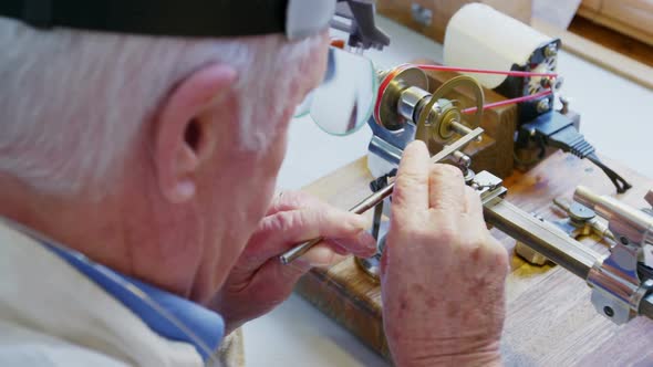 Horologist repairing a watch