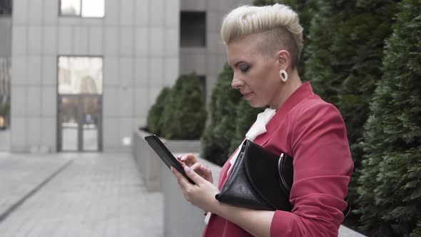 Girl Typing on a Digital Pad Near the Business Center